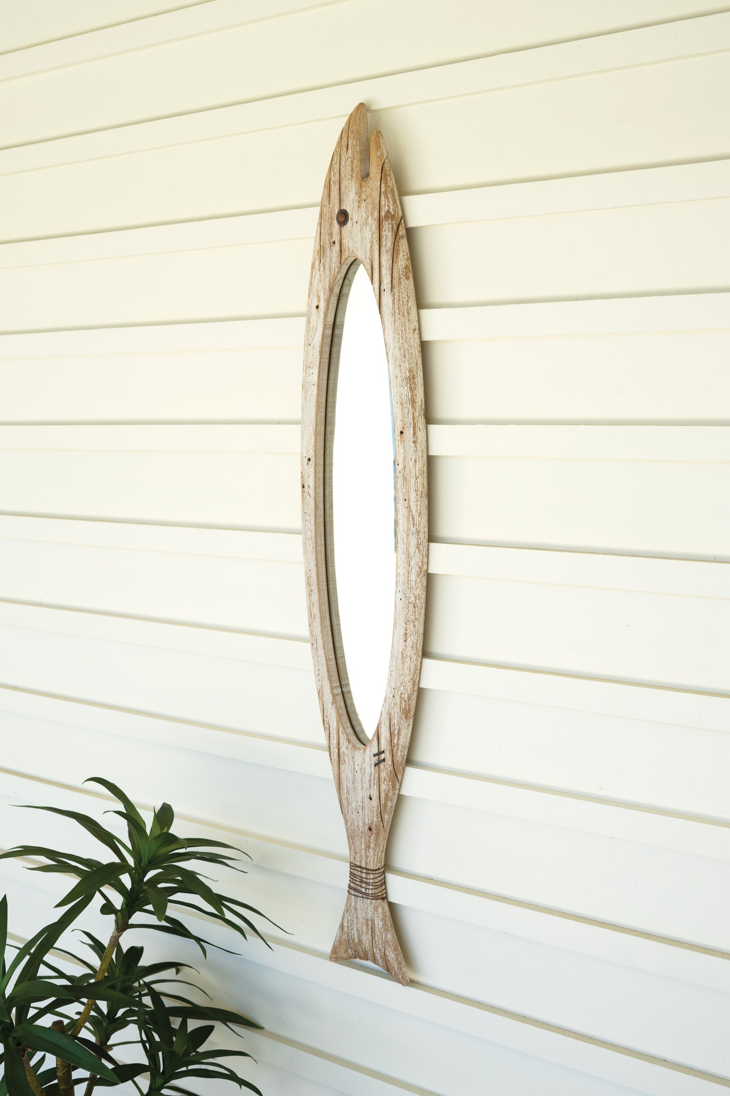 CarvedWoodenFishMirror-1 - Wooden wall mirror with natural finish on a light wooden panel background