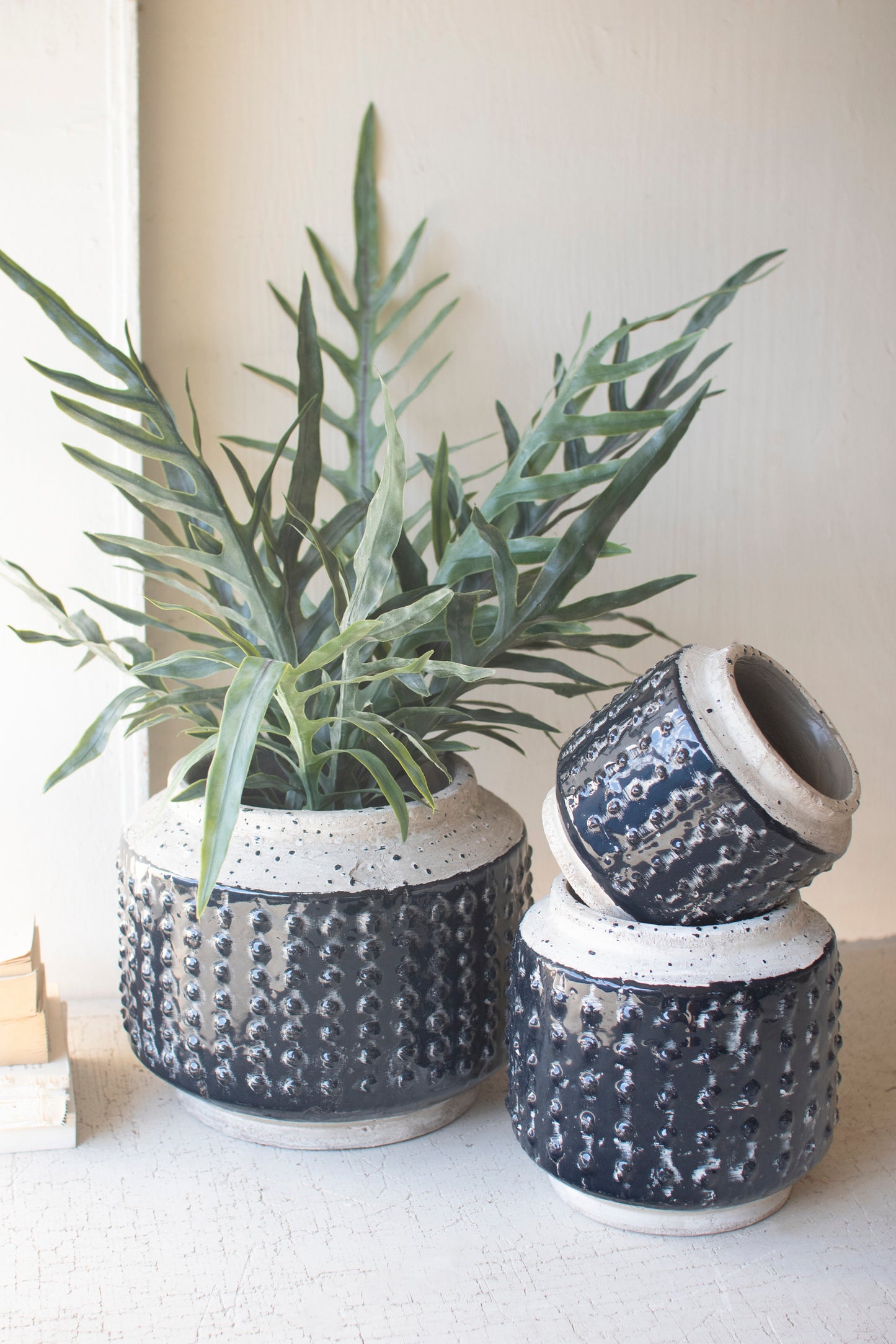 Dark Blue Knobby Ceramic Pots - Set of Three featuring three textured pots with plants, perfect for modern decor.