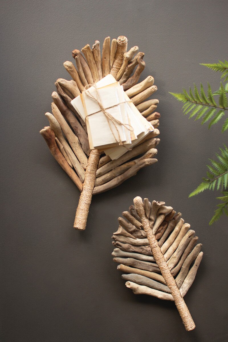 Decorative leaf-shaped baskets made from natural materials on a dark background