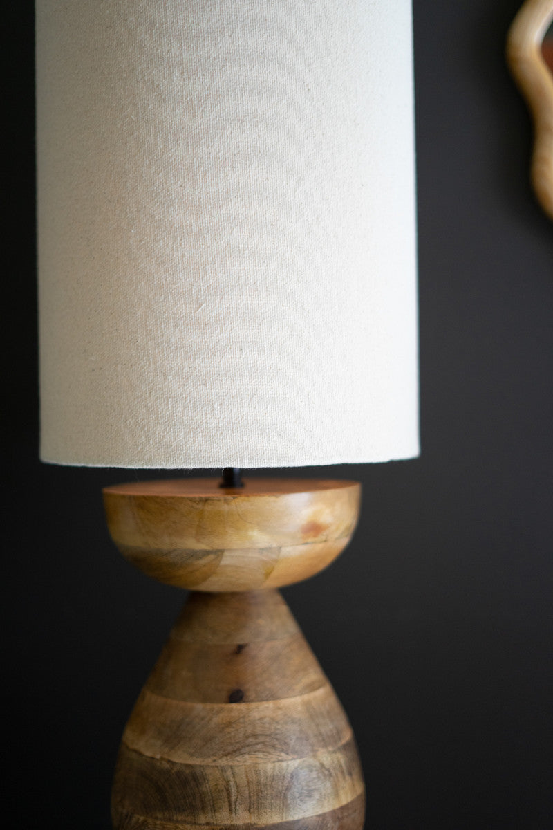 close up of mango wood table lamp with cream colored shade