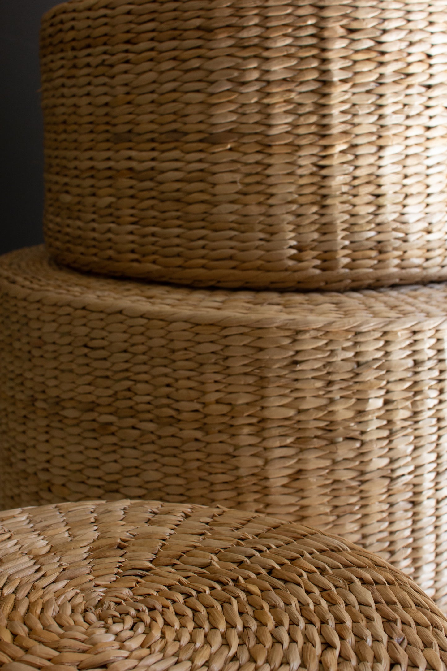 Round Natural Seagrass Risers - Set of 3 stacked atop each other, showcasing their natural weave and texture.