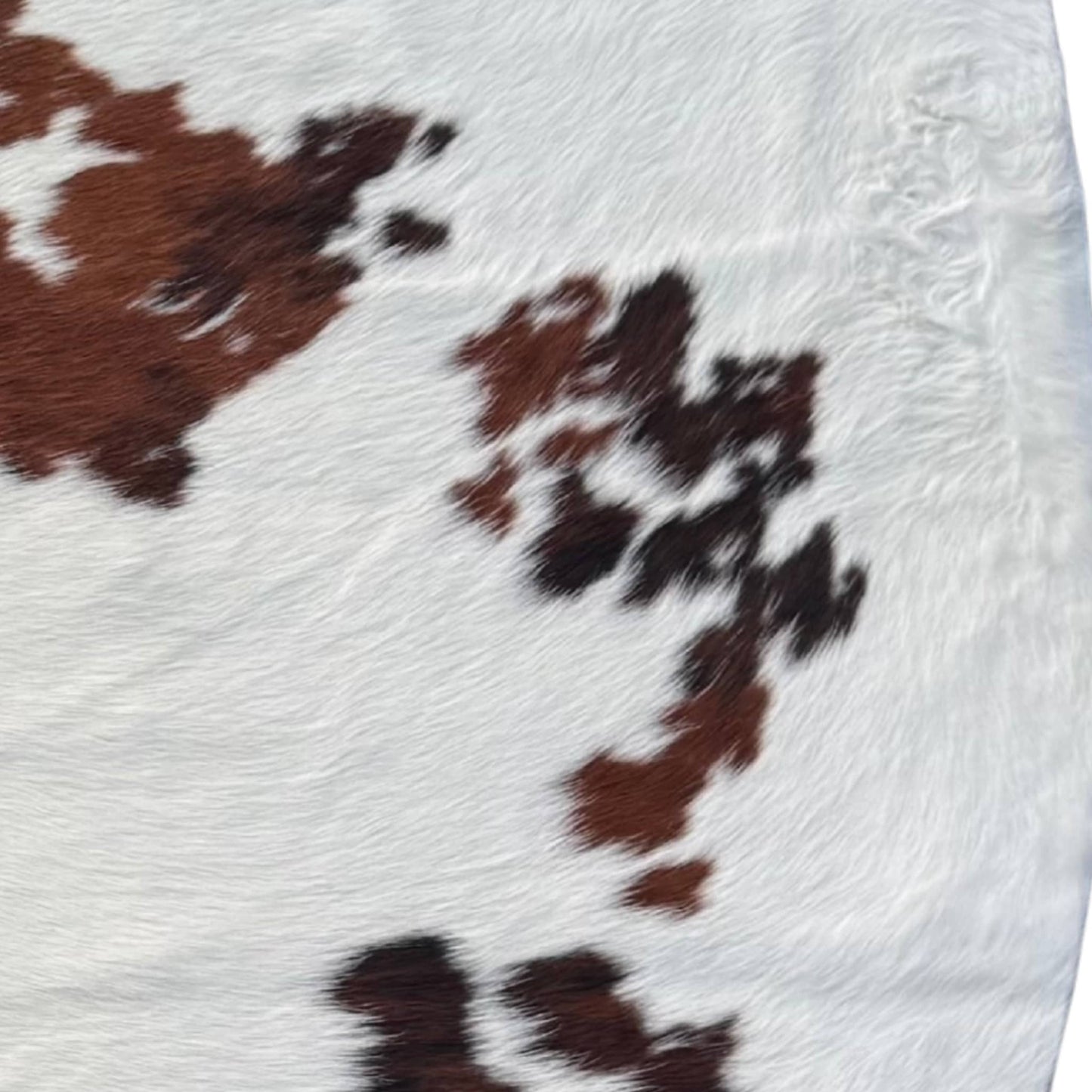 close up of brown black and white cowhide rug