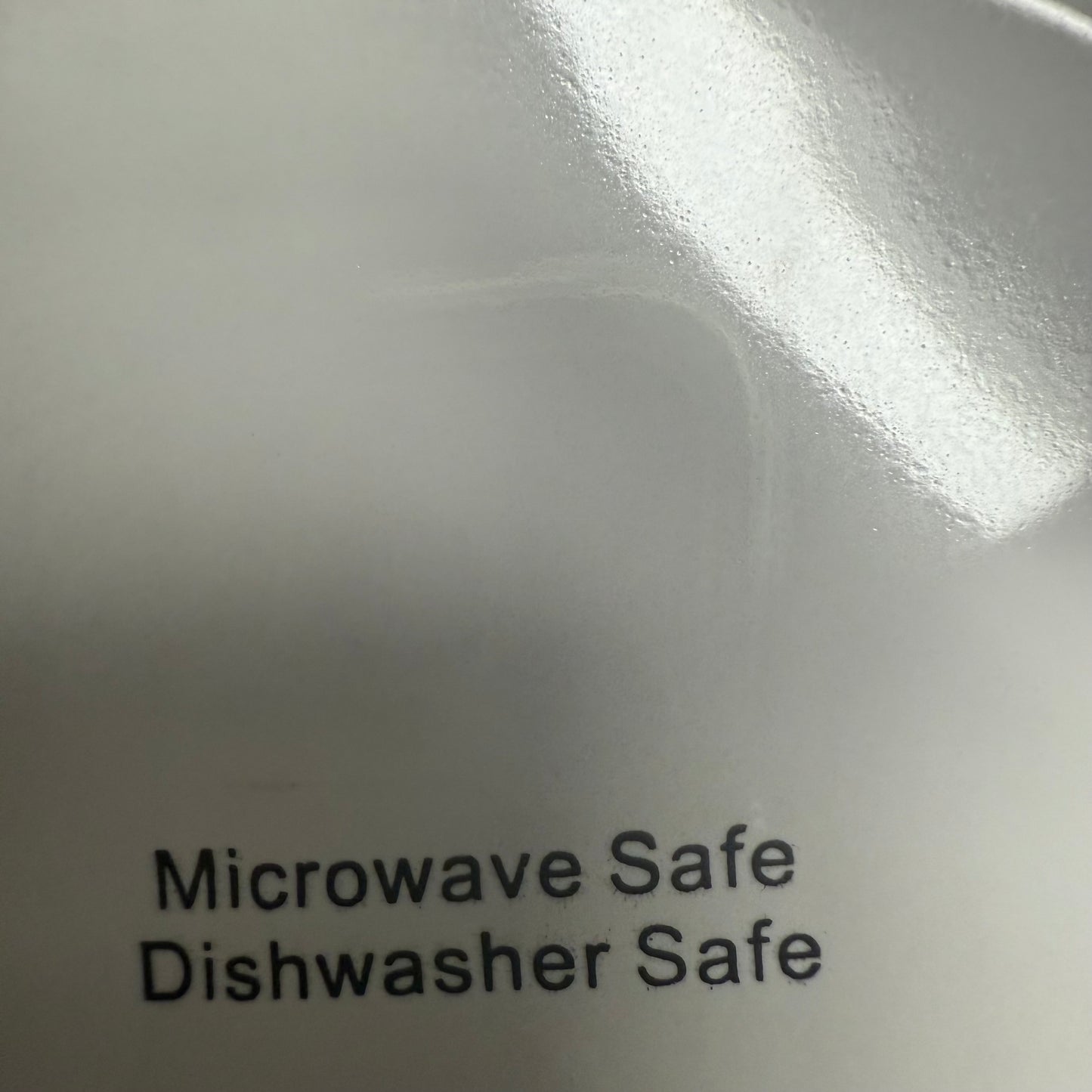 White Ceramic Mixing Bowl with labels indicating it is microwave safe and dishwasher safe.
