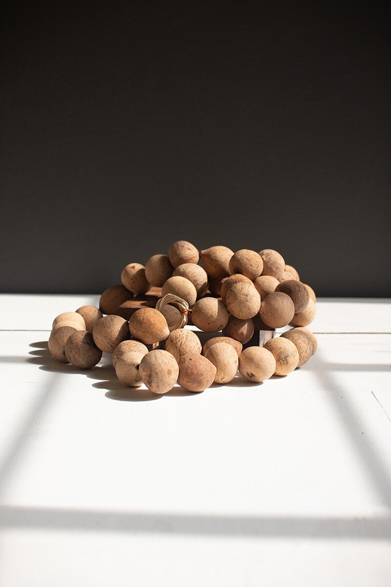 Dried Gourd Ball Garland showcasing round gourd balls, perfect for adding organic texture to home decor.