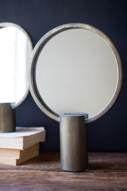 2 Round Antique Gold Mirrors with a dark background