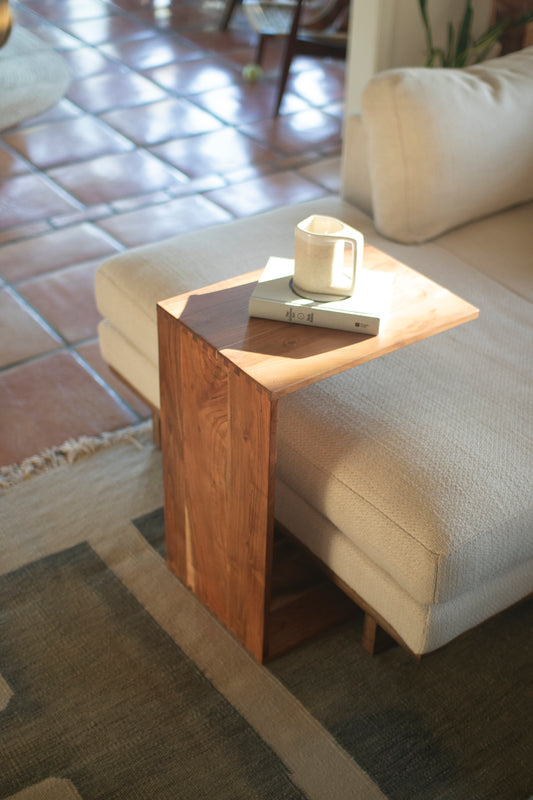 Acacia Wood Accent Table beside a sofa, holding a coffee mug and a book, perfect for a cozy modern rustic setting.