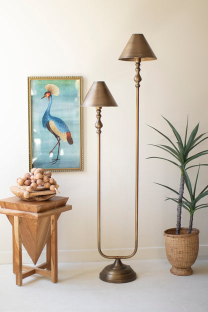 Antique Gold Double Floor Lamp with Metal Shades beside a vibrant bird painting and greenery in a cozy setting.