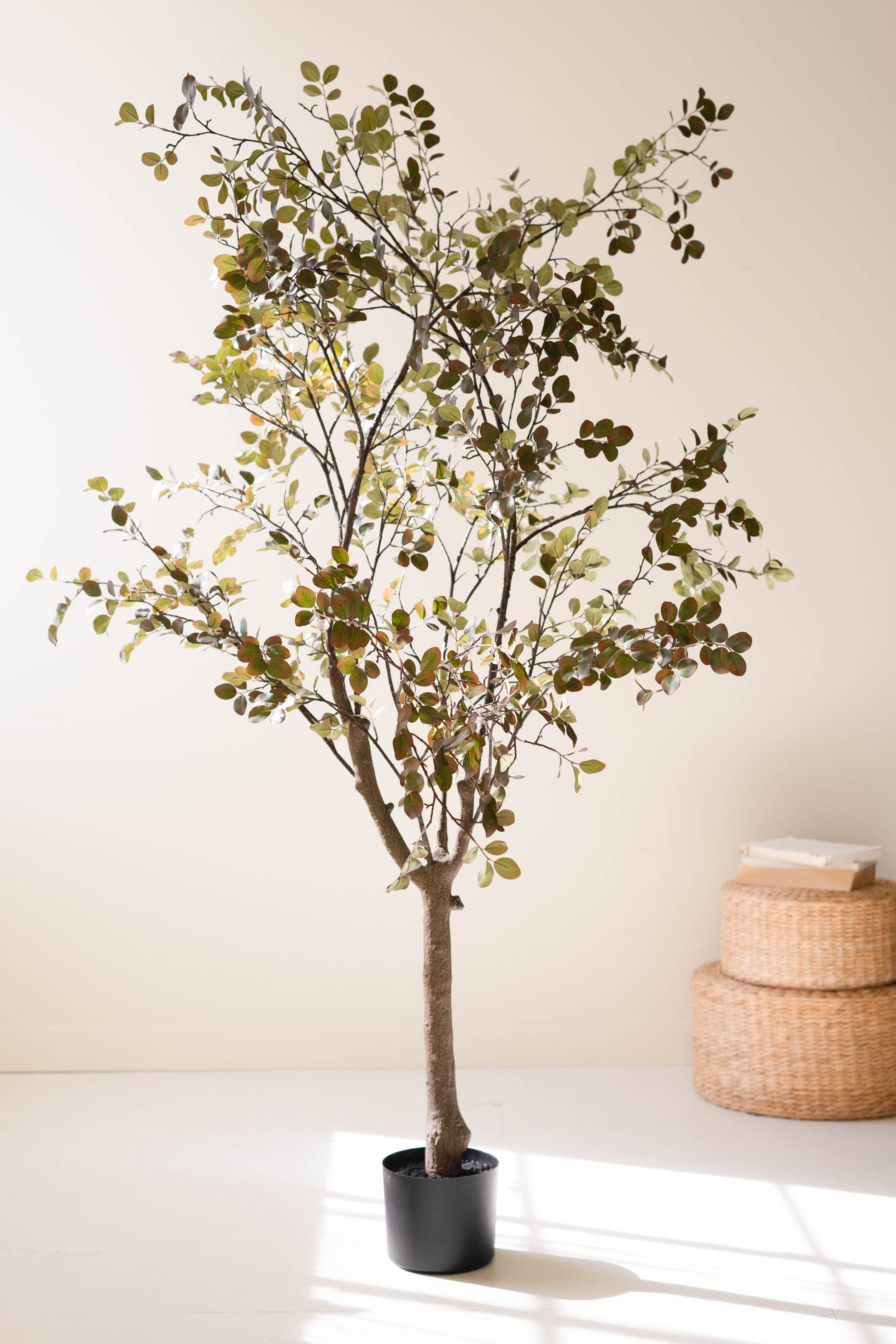 ArtificialCrepeMyrtleTreeinaBlackPlasticPot-1 - Potted artificial tree in a room with a neutral background
