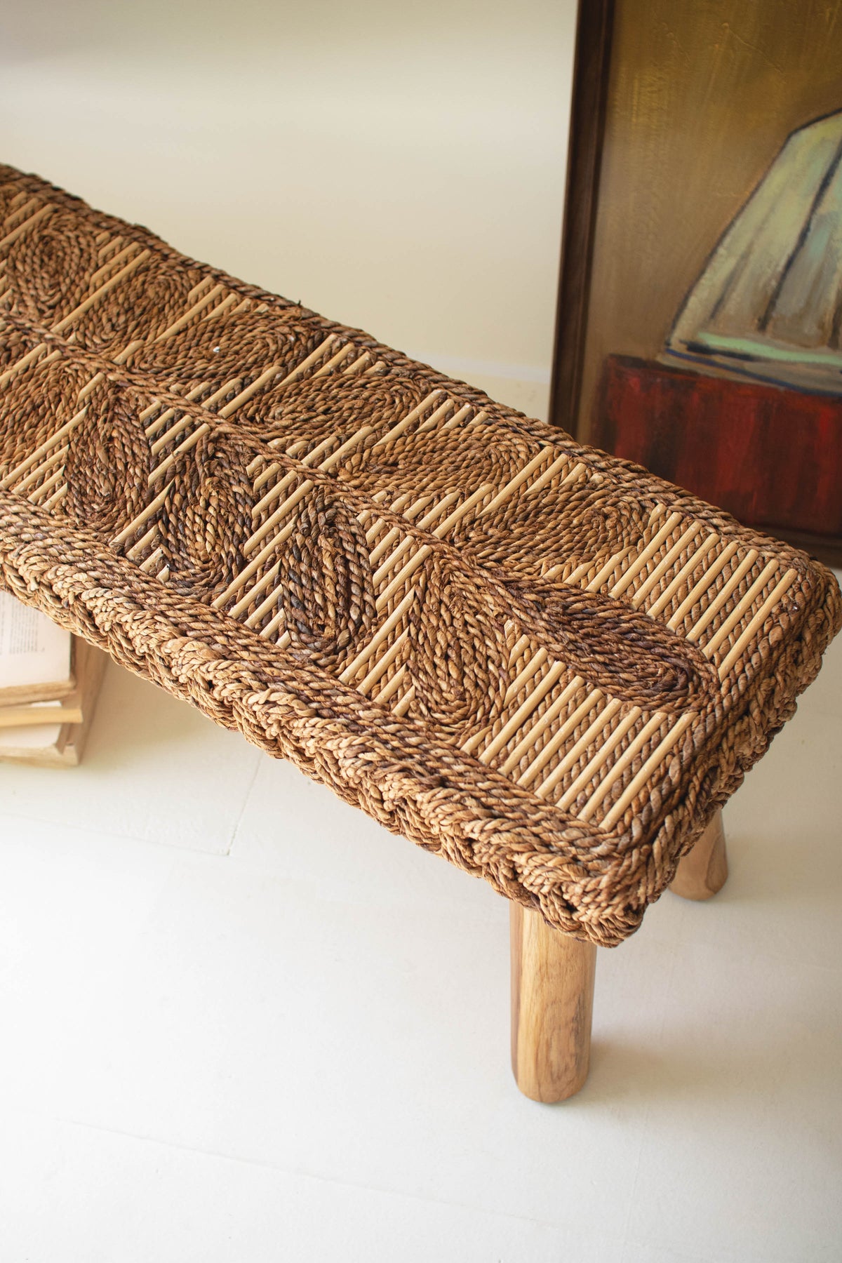 Banana Fiber and Teakwood Bench featuring a hand-woven natural fiber seat with intricate leaf patterns and sturdy wooden legs.