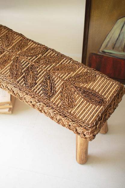 Banana Fiber and Teakwood Bench featuring a hand-woven natural fiber seat with intricate leaf patterns and sturdy wooden legs.