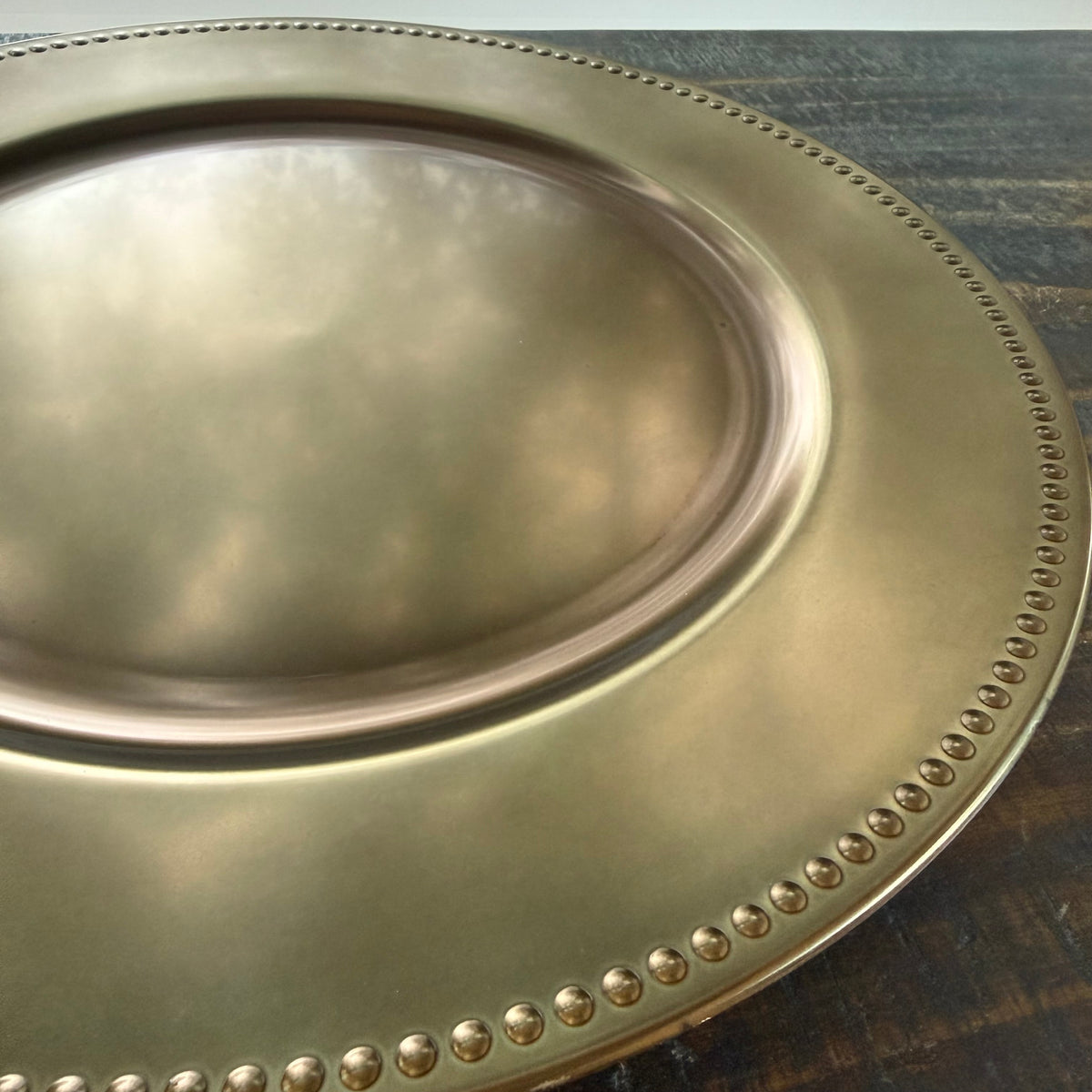 up close of bronze plate charger