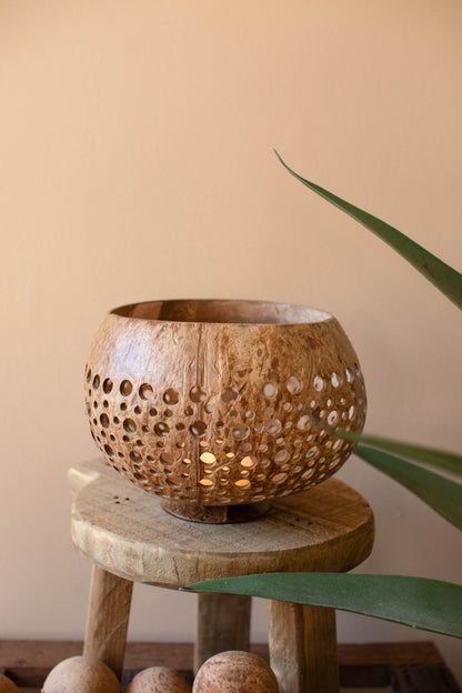 Carved Coconut Luminaries - Set of 2 showcasing hand-carved details and warm tones on a rustic wooden stool.