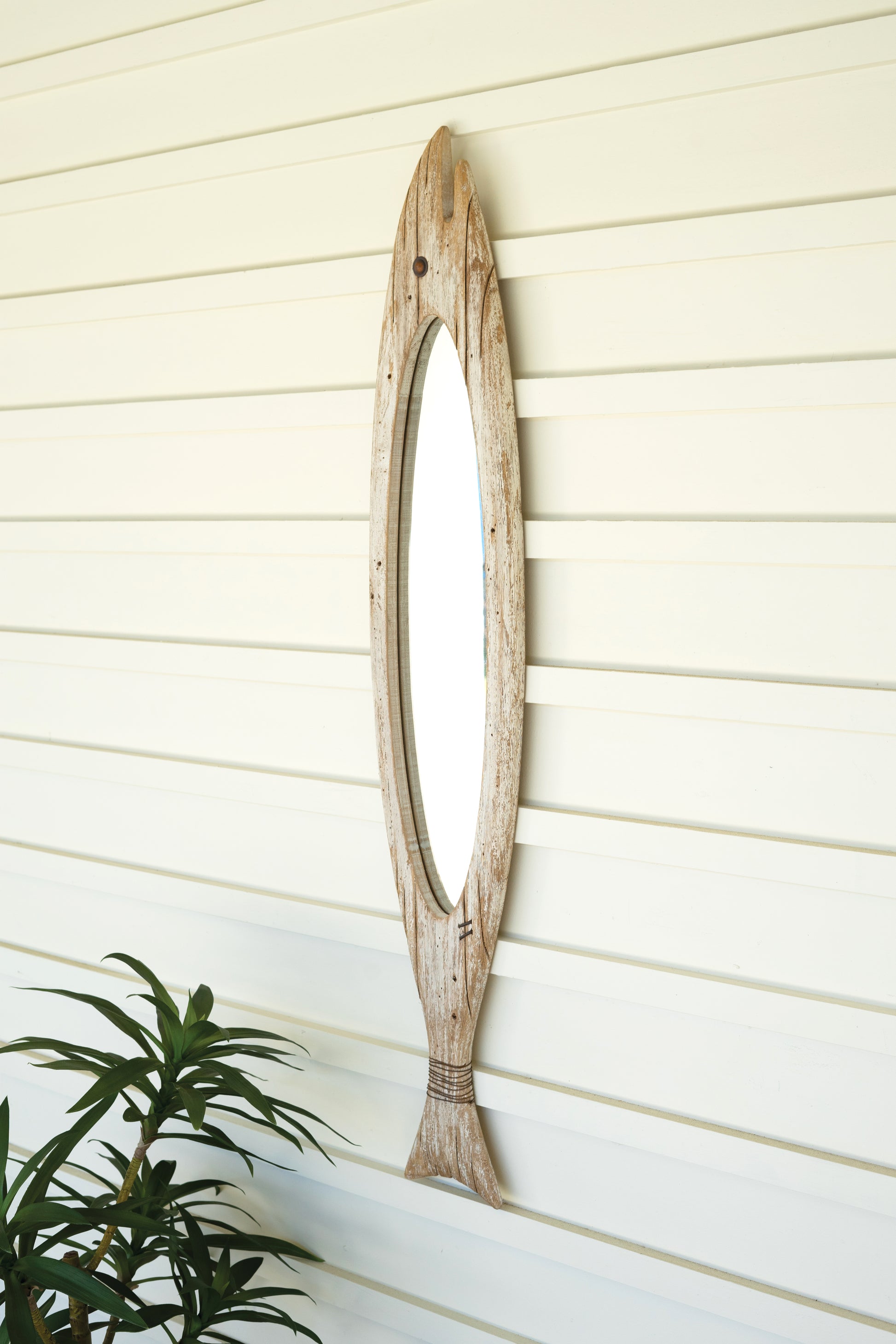 CarvedWoodenFishMirror-1 - Wooden wall mirror with natural finish on a light wooden panel background