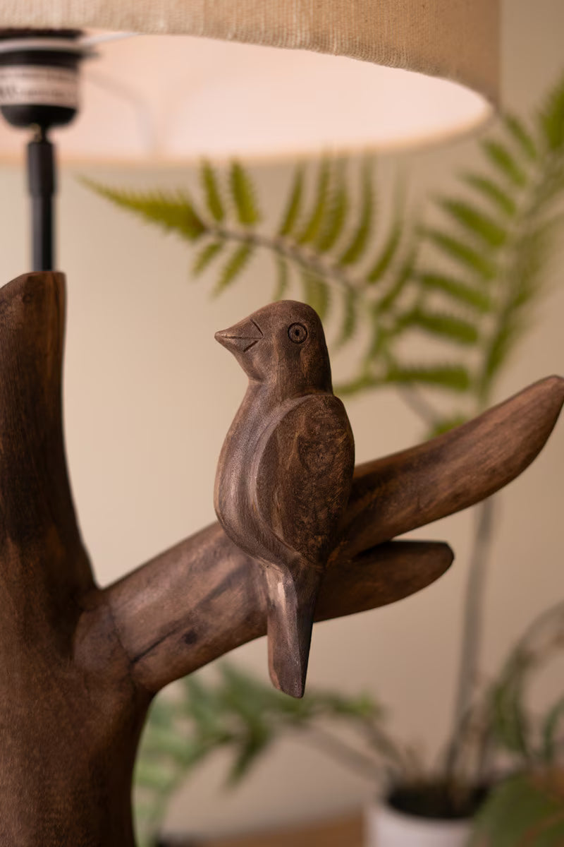 Carved Mango Wood Bird Table Lamp and plant in the background