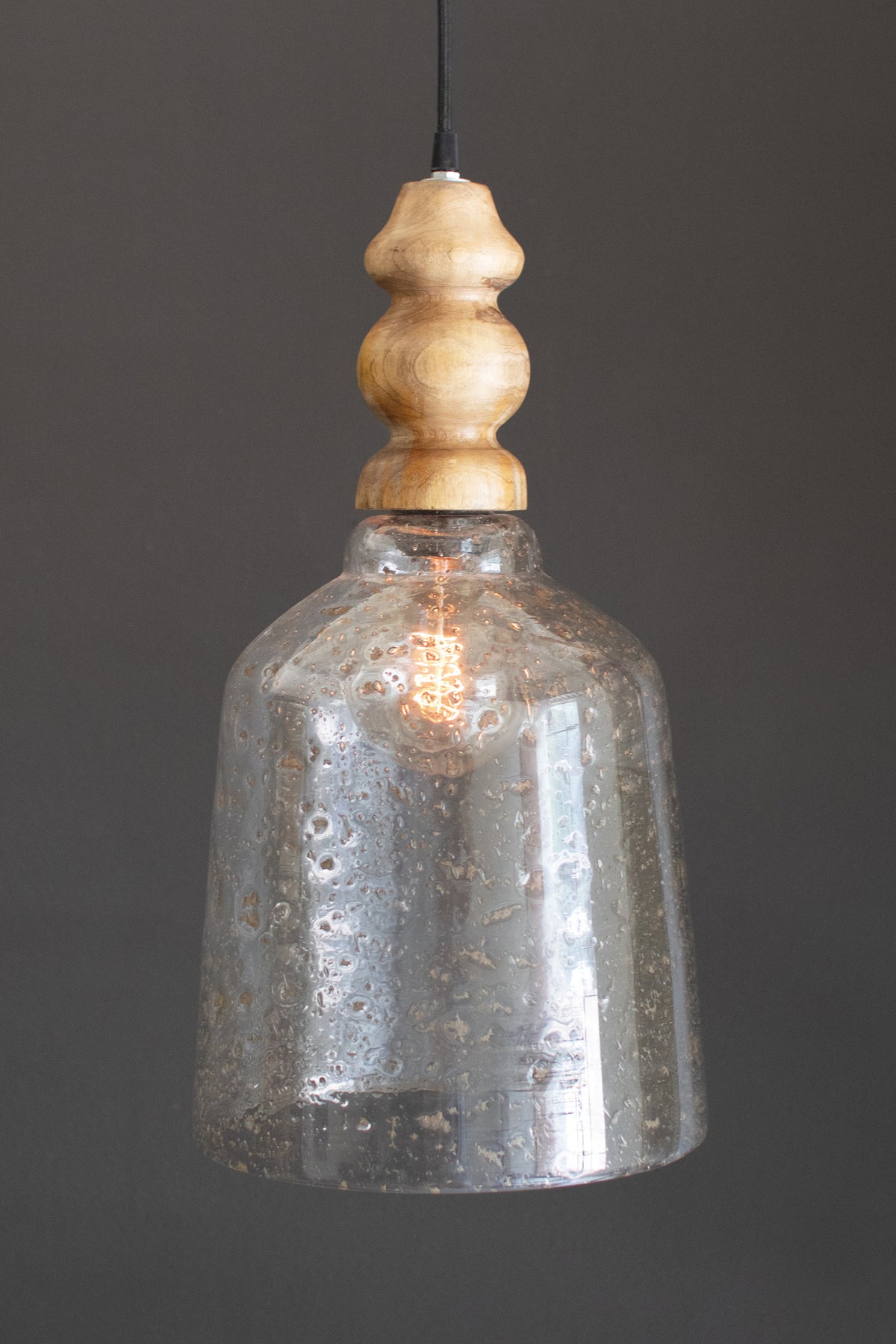 Glass Pendant Light with Wooden Finial featuring a pebbled glass shade and wooden accent, suspended from a cord.