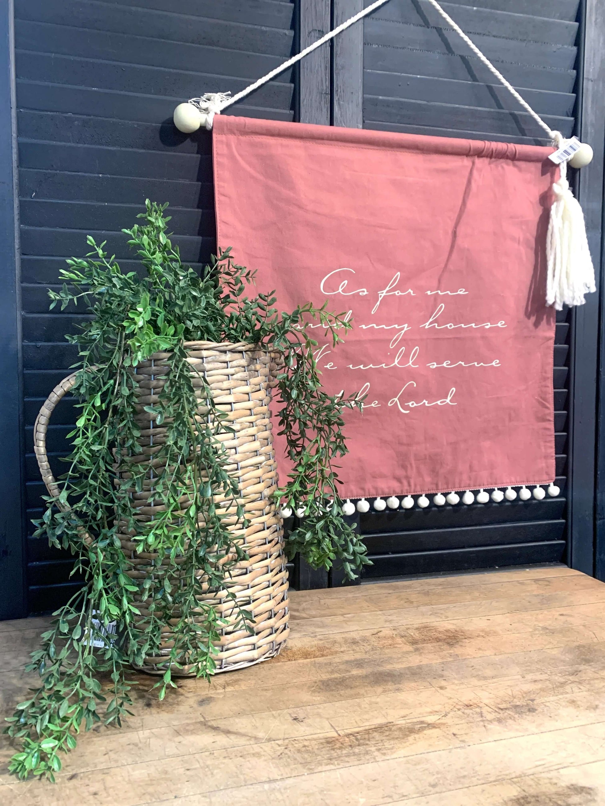 Wall hanging, wicker pitcher and boxwood greenery