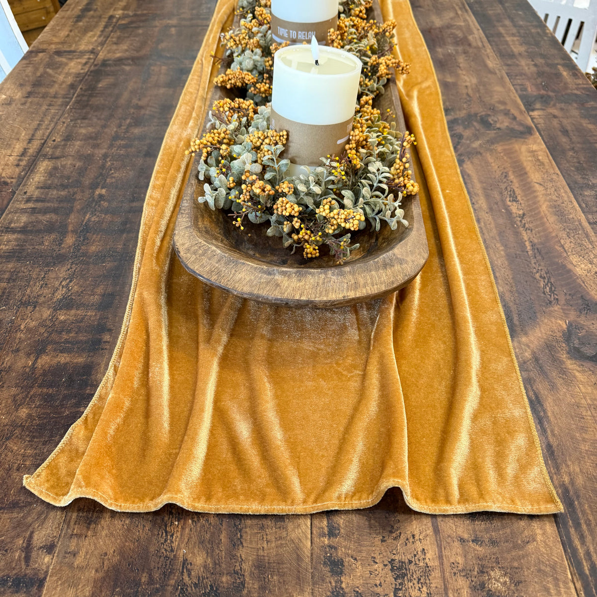 velvet gold table runner with fall centerpiece on table