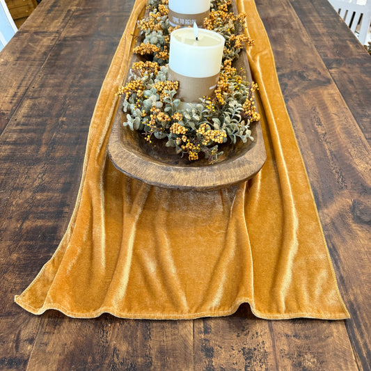 velvet gold table runner with fall centerpiece on table
