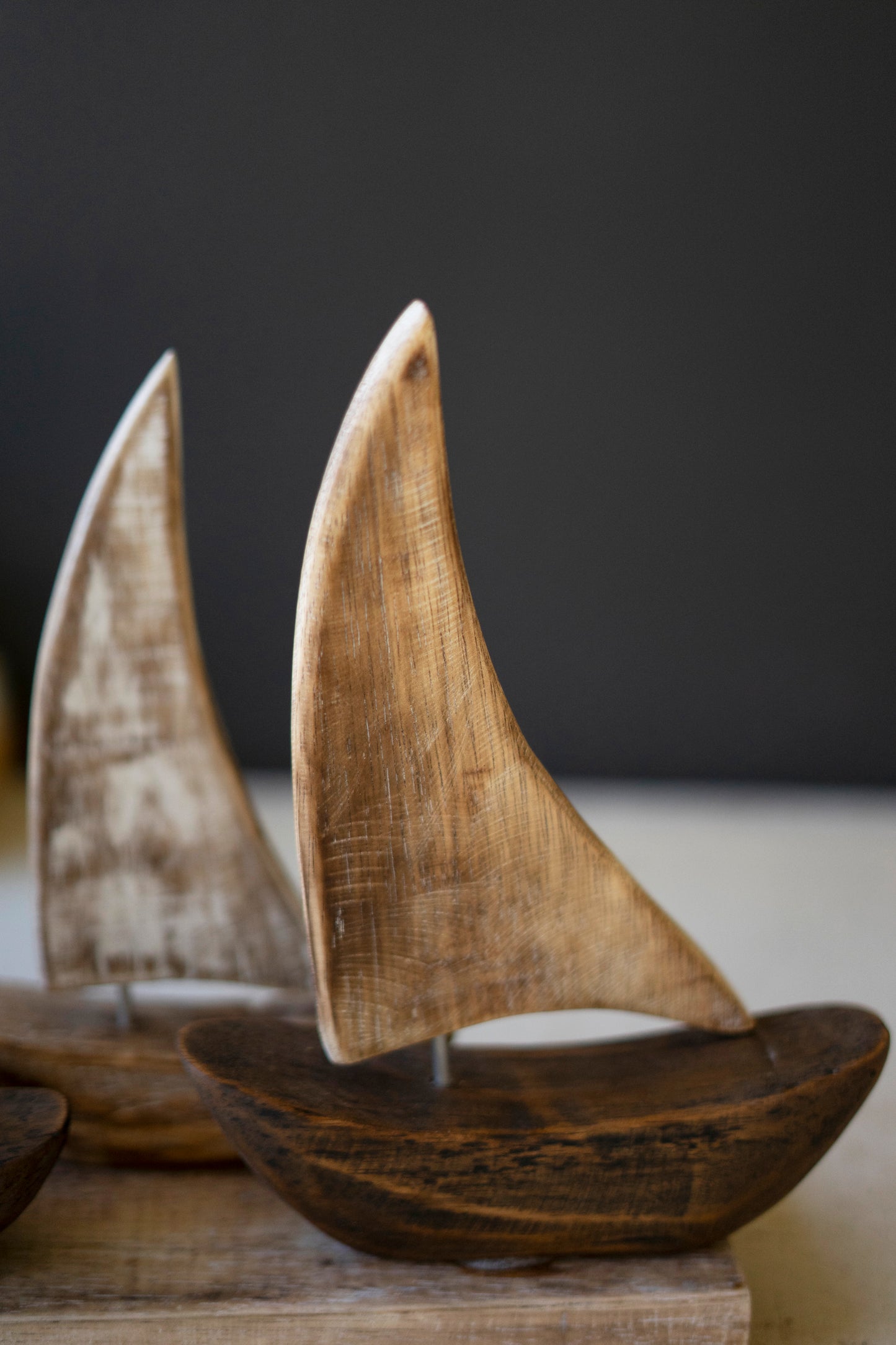 FiveWoodenSailboatsonaBase-2 - Wooden sailboats on a dark background