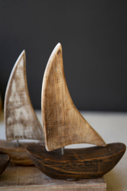 FiveWoodenSailboatsonaBase-2 - Wooden sailboats on a dark background