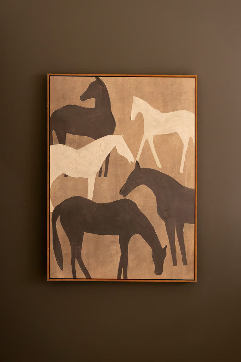Framed Painting of Five horse silhouettes in black, white, and dark brown hung on a dark brown wall.