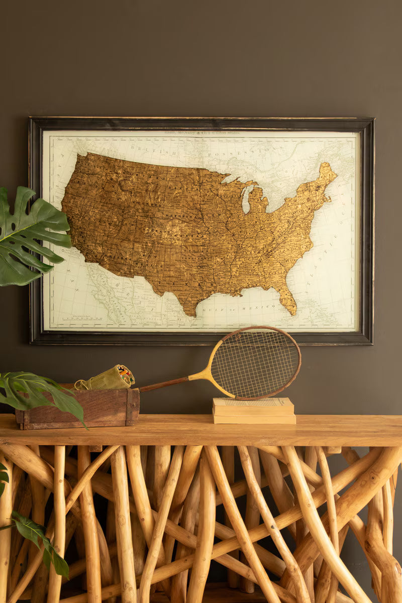 Framed USA Map Print with Gold Leaf Under Glass on a wooden console table with a vintage racket and decorative box.