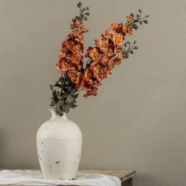 orange and pink faux foral in white vase