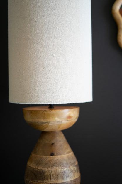 close up of mango wood table lamp with cream colored shade