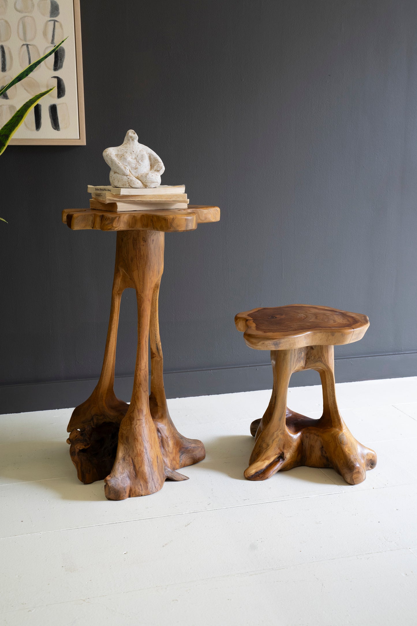 OrganicTeakwoodAccentTables-SetofTwo-2 - Two wooden side tables with a dark gray wall and white floor in the background.