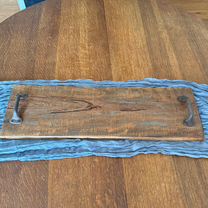 Wooden cutting board with a handle on a round wooden table