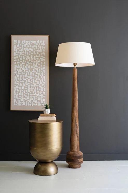 Decorative wood floor lamp and brass vase in modern rustic space
