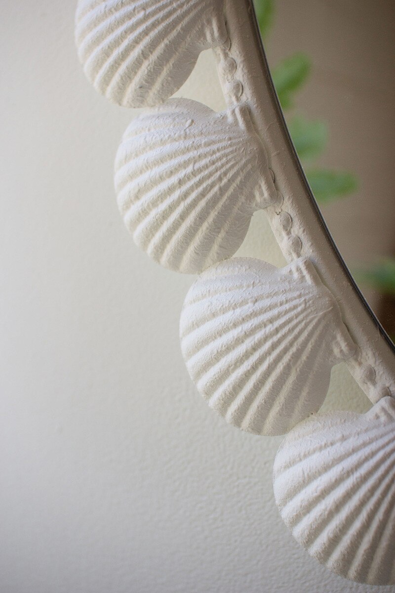 White Shell Framed Oval Mirror on a light background