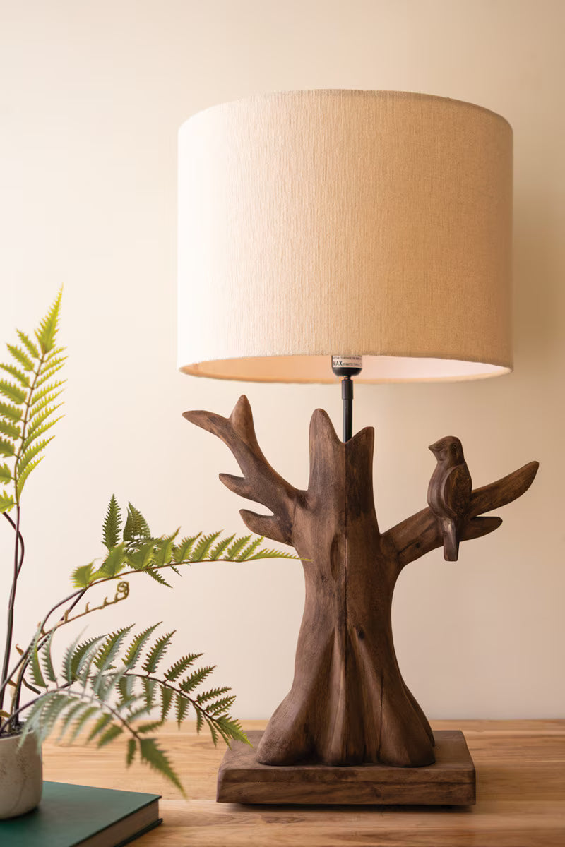 Wooden Bird Table Lamp with wooden base and bird design on a wooden surface