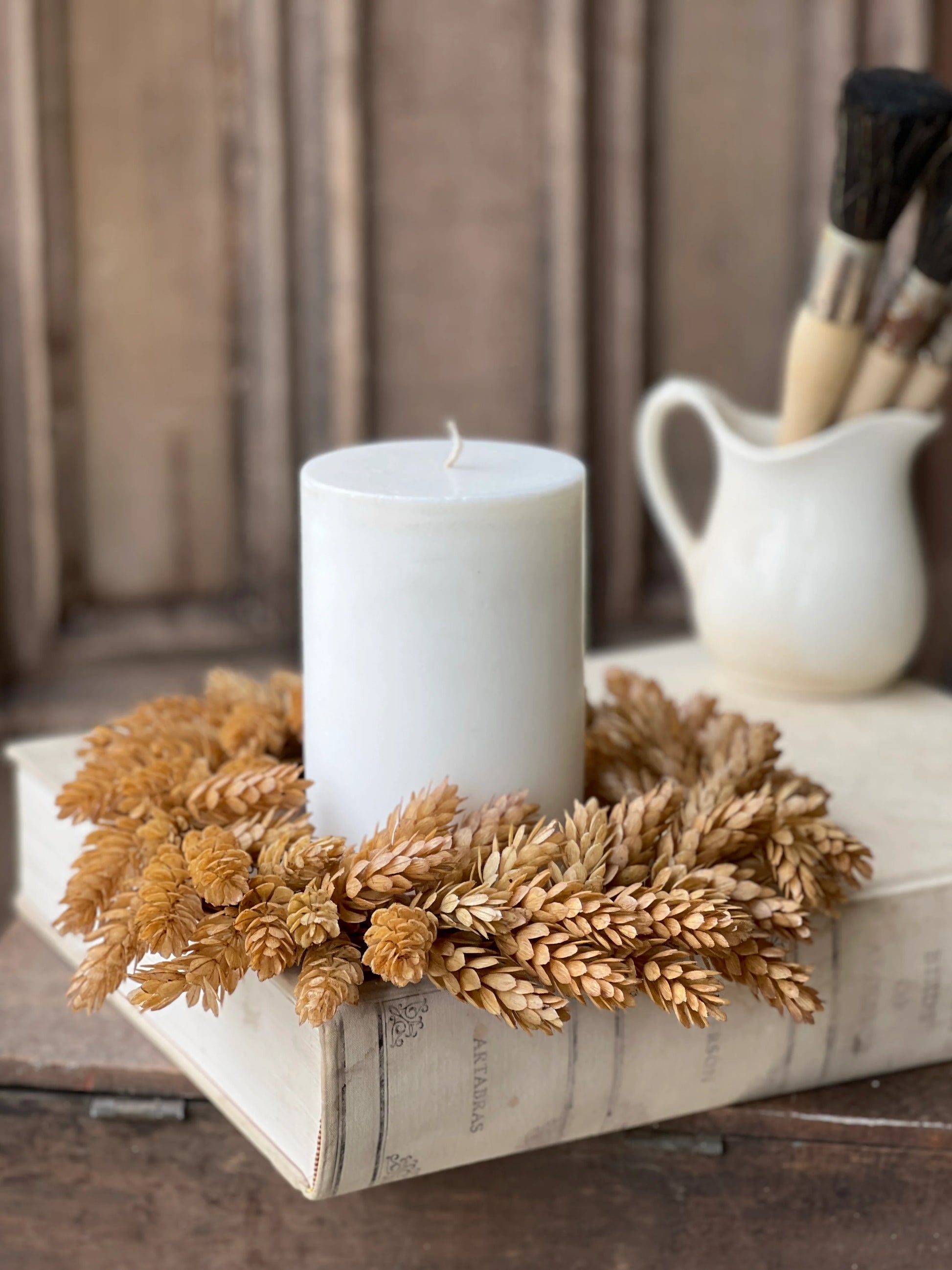 beige hops - large candle ring for fall with white candle sitting on old book