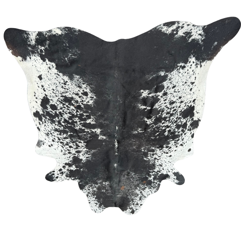 Black and white cowhide rug on a white background