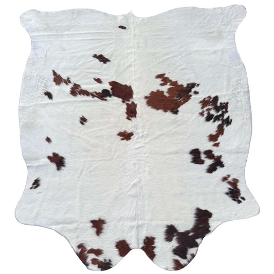 brown and white cowhide rug on white background