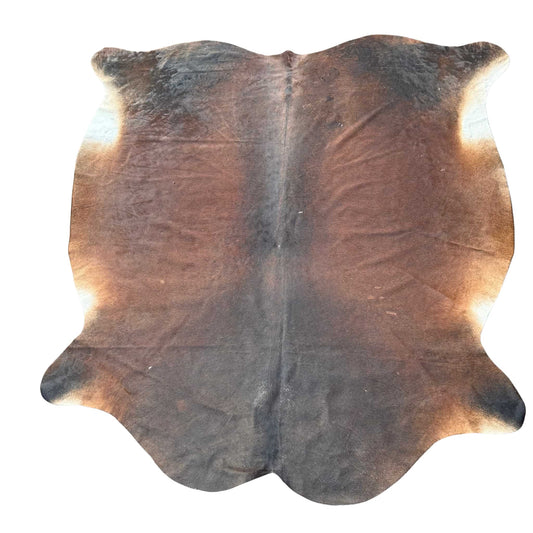 Brown cowhide rug on a white background