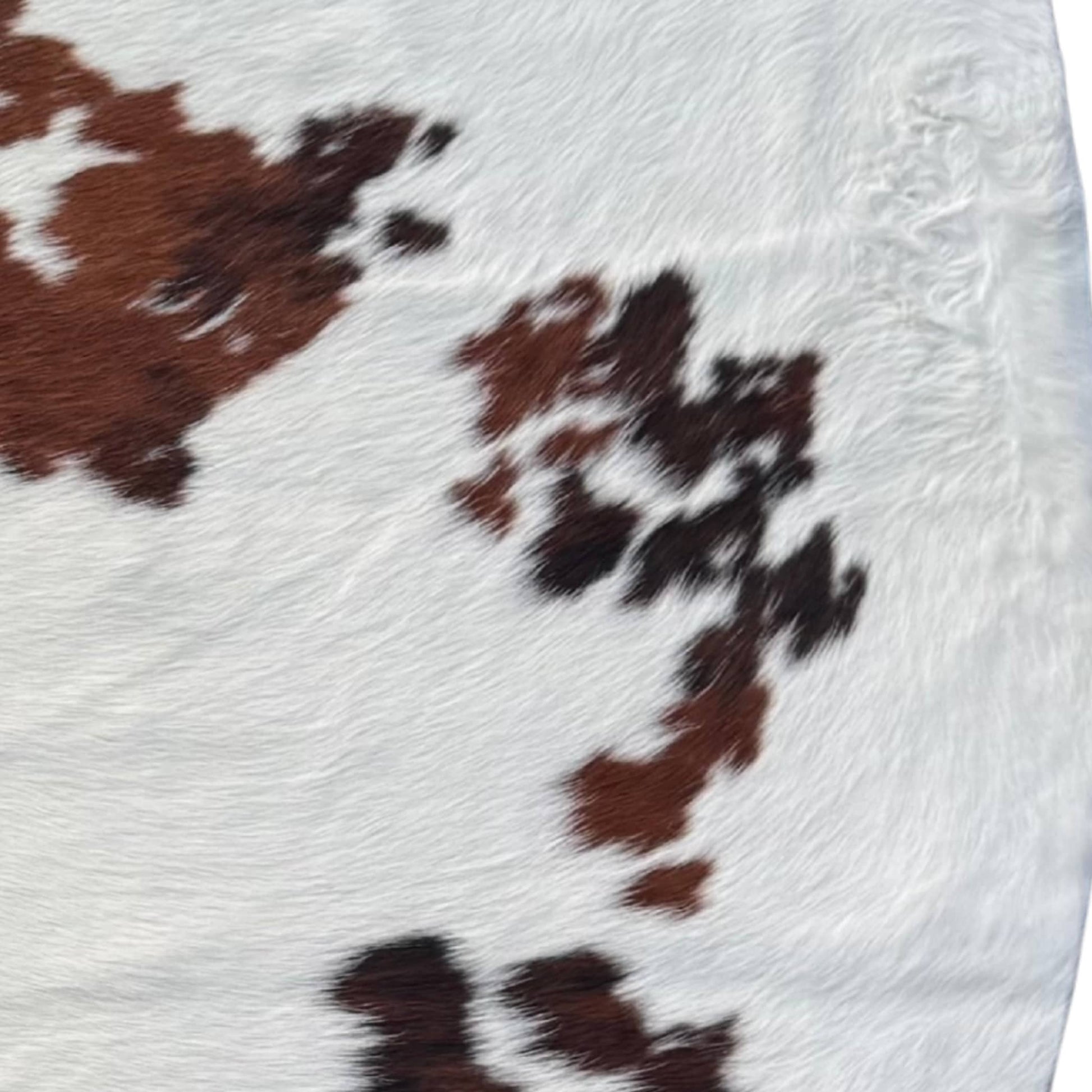 close up of brown black and white cowhide rug