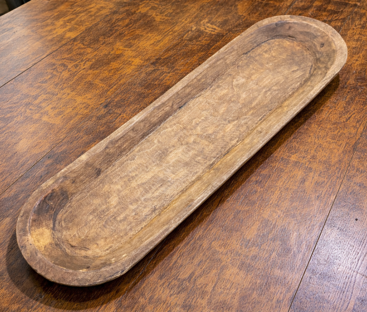 Large wooden rectangular tray on a wooden table