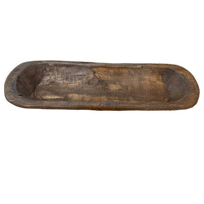 narrow rustic wood bowl on table runner