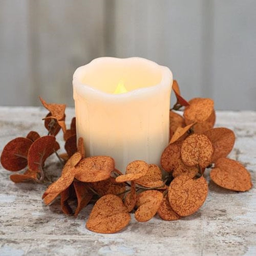 Orange penny leaf candle ring around a pillar candle