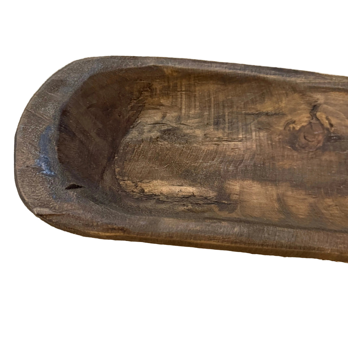 A dark brown carved bowl close up