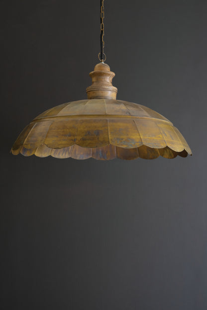 Antique Brass Dome Pendant Light with Wood Detail hanging with a scalloped brass dome and wooden detail against a dark background.