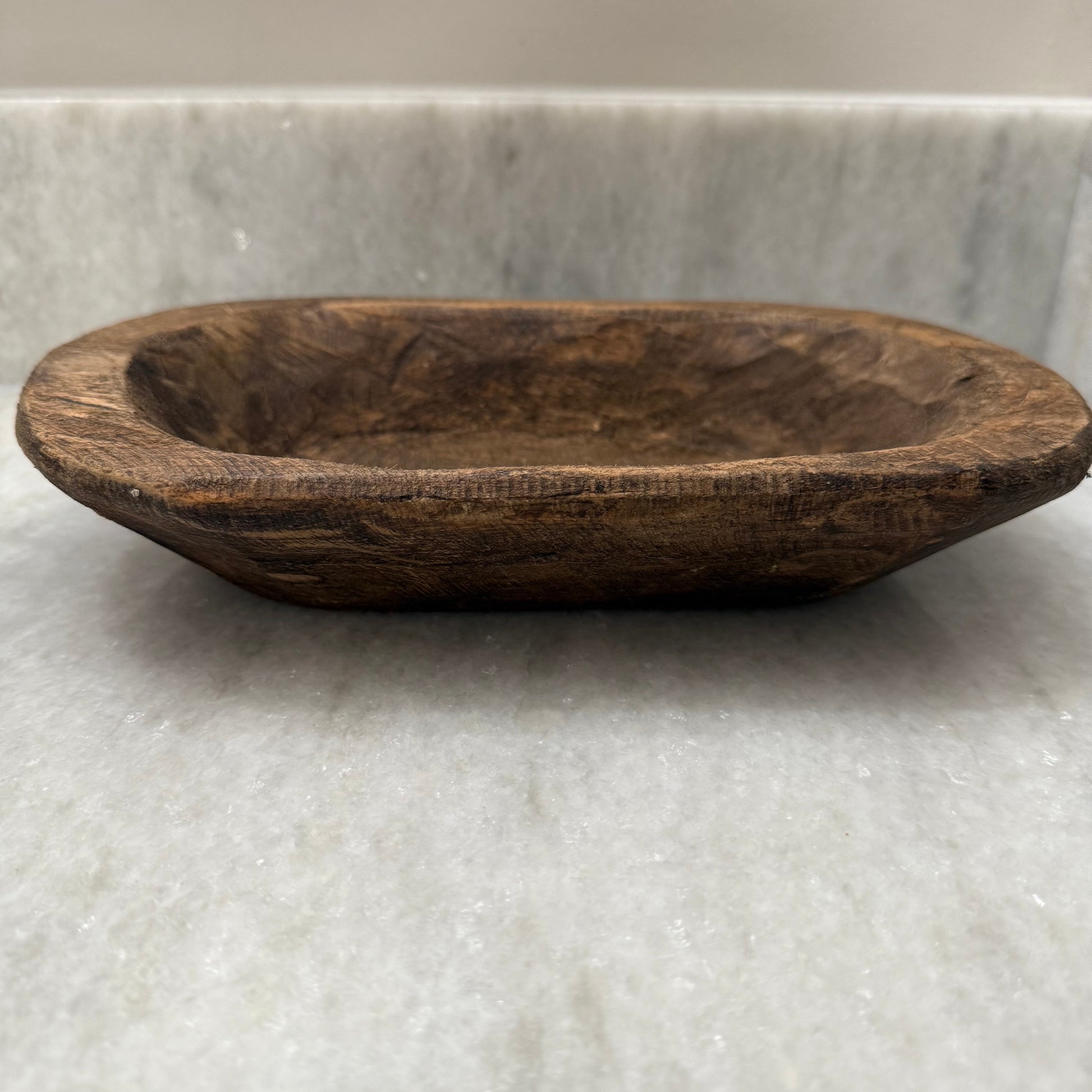 Wooden bowl on a marble surface