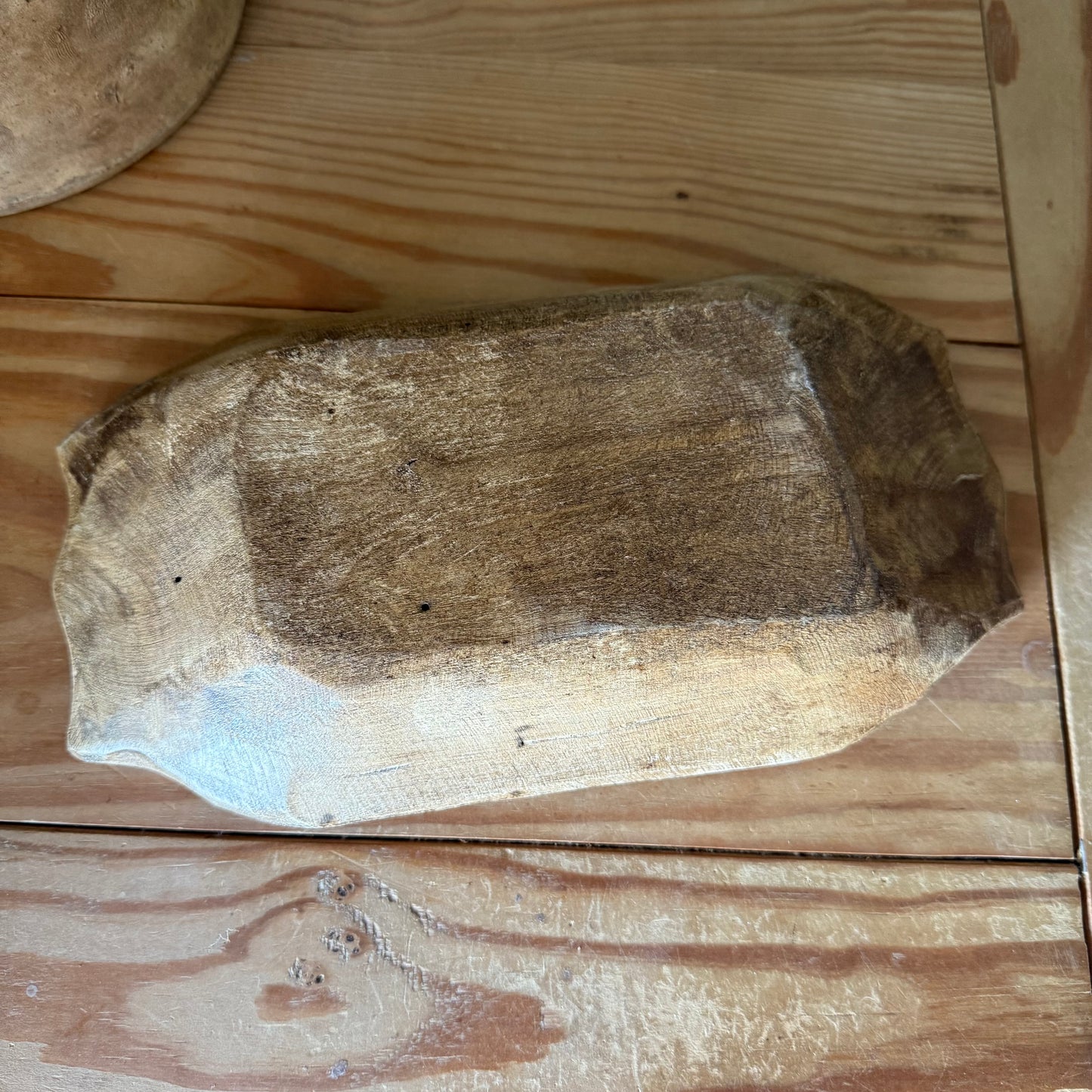 back of small rustic wood bowl