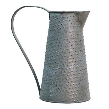 Metal pitcher with a textured surface on a white background