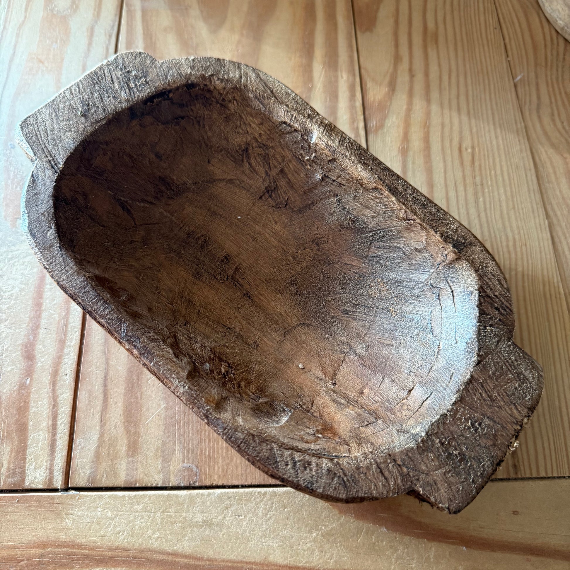 Wooden dough bowl on a wooden surface
