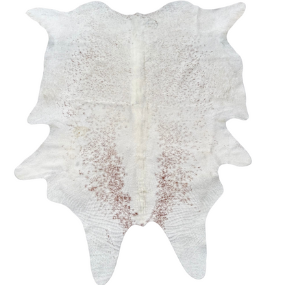 White cowhide rug with brown patches on a white background